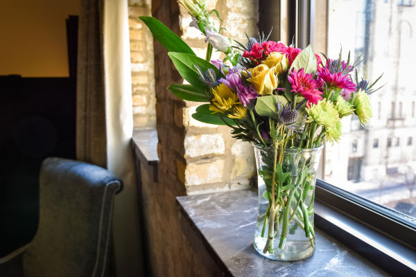 Spacious historic hotel suite with exposed brick and modern furnishings at Brewhouse Inn & Suites in downtown Milwaukee.